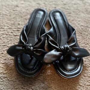 Black flip flops with bows